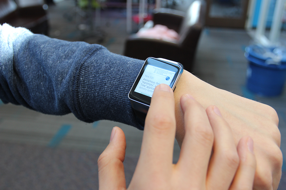 A user working on a document on a smartwatch using WearWrite, by leveraging a crowd to help trans¬≠late their ideas into text.